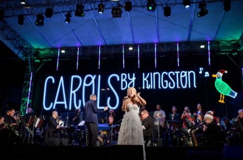 Performers on stage at a previous Carols by Kingston