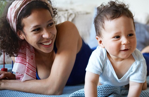 A woman smiling at a child