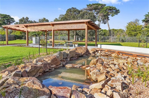 An undercover picnic area and water feature at Christina Terrace Reserve