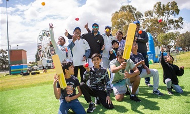 Cricket team posing on a field